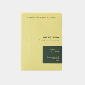 Yellow package of 'Immunity Hero' with pineapple and lemon flavor on a white background