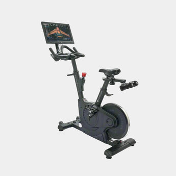 Black exercise bike with digital display on a white background