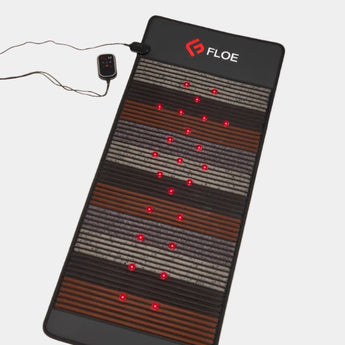 Floe heating pad with red LED lights on a beige background