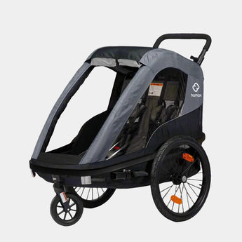 Gray and black stroller with a visible brand logo on a gray background