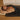 Man lying on a mat with a black cover labeled 'Chirodeck' in a bedroom setting.