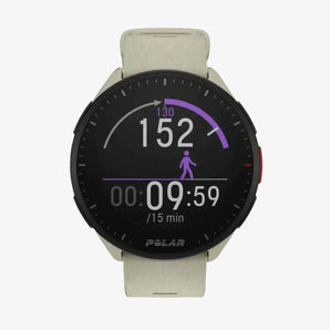 A person wearing a light-colored shirt with a Polar Pacer GPS Sports Watch on their wrist. The watch has a black display and appears to have a white or light-colored band.