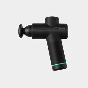 A portable black Hyperice Hypervolt Go 2 massage gun with a sleek design, featuring a control dial and two head attachments.