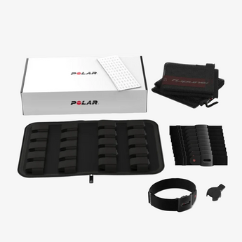 Polar fitness device components including a case, strap, and packaging on a white background