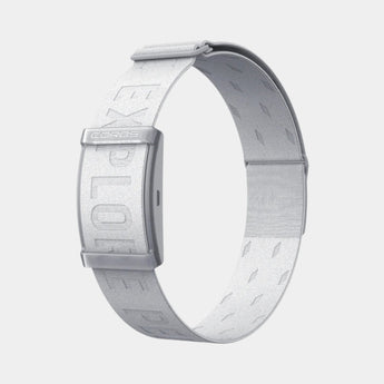 An image of a person jogging wearing a red top and black shorts, with a white heart rate monitor band on their left wrist.