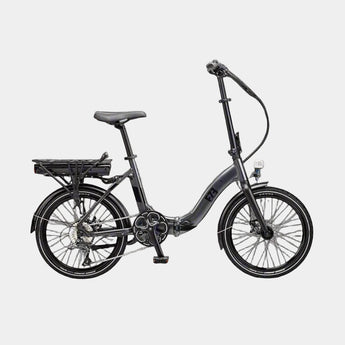 Black folding bicycle on a paved surface with a modern building in the background