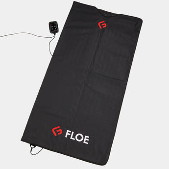 Black heating pad with 'Floe' branding on a beige background