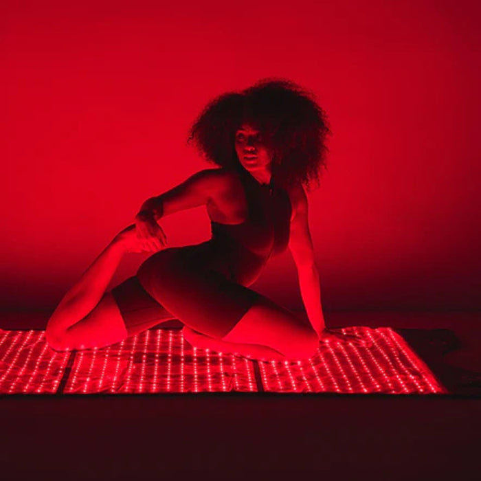Person sitting on a grid with a red light background