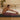 Man practicing yoga on a mat in a living room setting