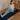 Woman practicing yoga on a mat with a wooden floor and white wall background