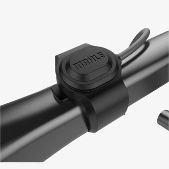 Mahle E-Shifters mounted on a bicycle handlebar, consisting of a small black rectangular device with the brand name visible.