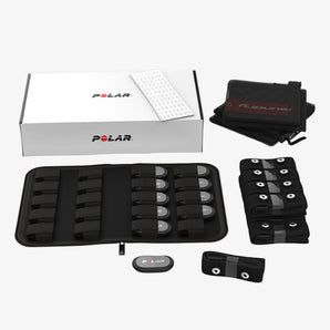 Polar heart rate monitor components including straps and case on a white background