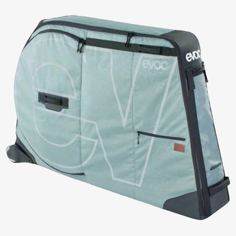 An EVOC bike travel bag in gray color with the brand logo visible on the side. It features a foldable design and replaceable skate wheels for transport.