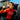 Cyclist in red INEOS Grenadiers jersey drinking from a SIS bottle.