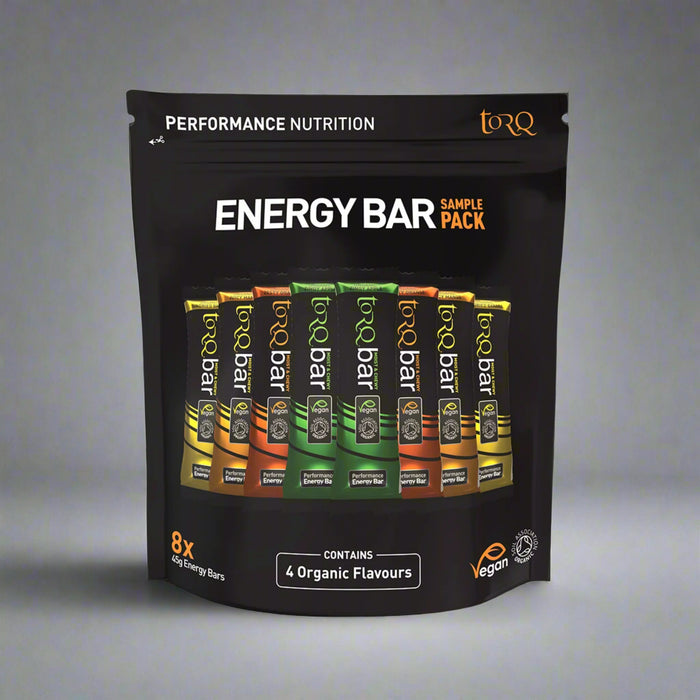 Pack of Torq energy bars with various flavors on a black background